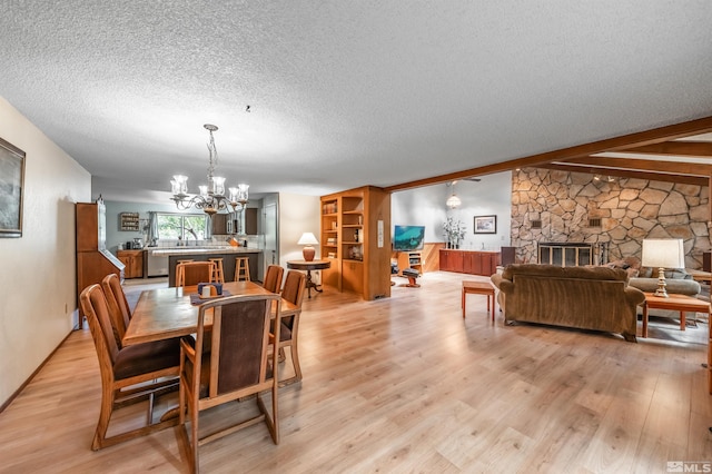 12565 Creek Crest Dr, Reno, NV 89511 - dining space with a chandelier, light wood finished floors, a textured ceiling, and beam ceiling