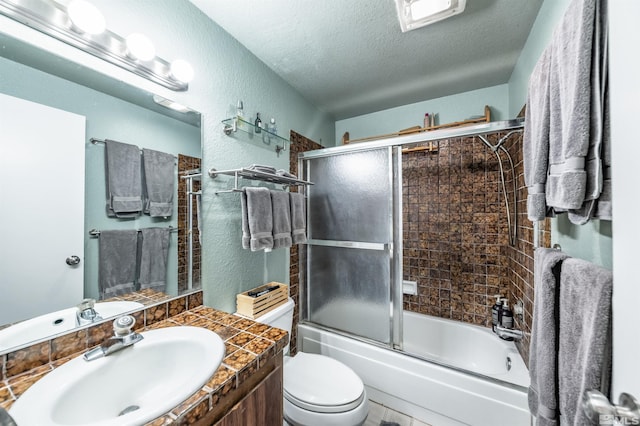 12565 Creek Crest Dr, Reno, NV 89511 - bathroom with a textured ceiling, a textured wall, combined bath / shower with glass door, vanity, and toilet