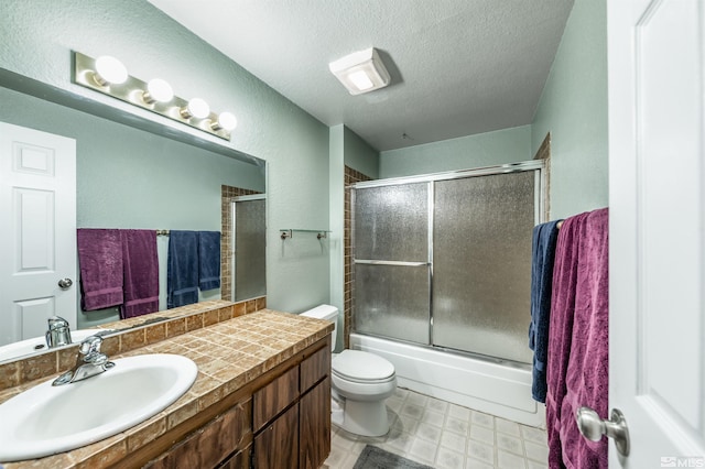12565 Creek Crest Dr, Reno, NV 89511 - full bathroom with a textured ceiling, toilet, vanity, tile patterned floors, and a textured wall