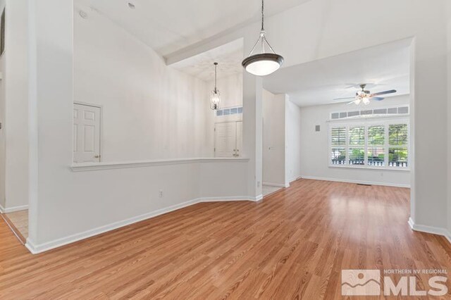 5979 Hidden Highlands Dr, Reno, NV 89502 - spare room with wood finished floors, a ceiling fan, baseboards, and vaulted ceiling