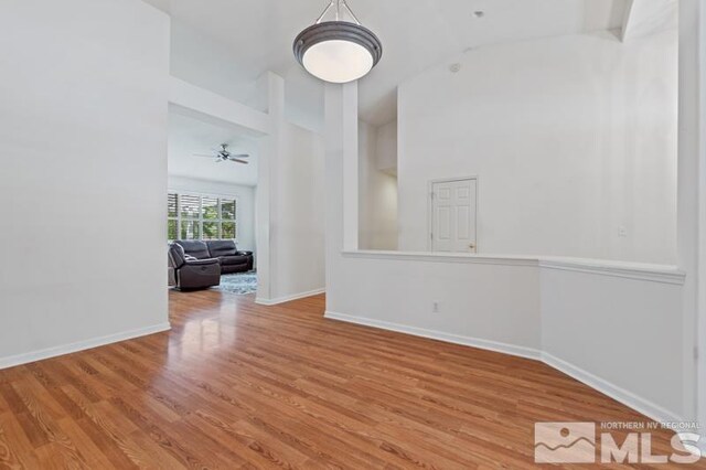 5979 Hidden Highlands Dr, Reno, NV 89502 - empty room featuring wood finished floors, baseboards, a ceiling fan, and high vaulted ceiling