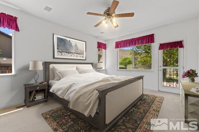 5979 Hidden Highlands Dr, Reno, NV 89502 - bedroom featuring light carpet, access to exterior, baseboards, and a ceiling fan