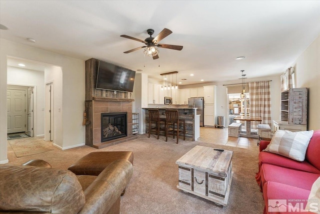 9185 Raytheon Ct, Reno, NV 89506 - living room featuring ceiling fan, light carpet, recessed lighting, a fireplace, and baseboards
