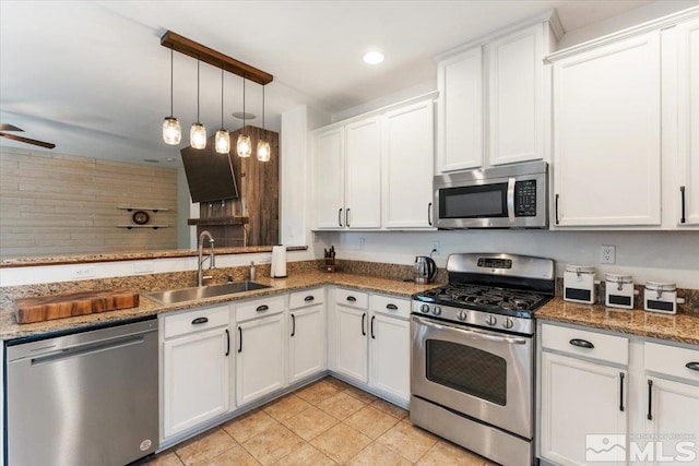 9185 Raytheon Ct, Reno, NV 89506 - kitchen featuring stainless steel appliances, a sink, light tile patterned floors, white cabinets, and ceiling fan