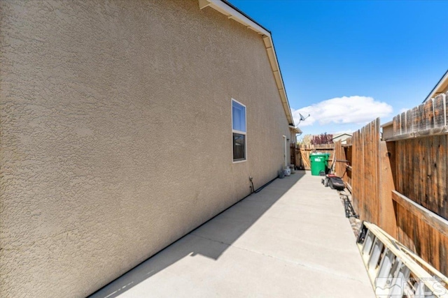 9185 Raytheon Ct, Reno, NV 89506 - view of home's exterior featuring stucco siding, fence, and a patio