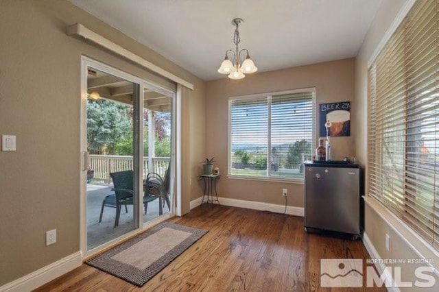 5284 Tappan Ct, Reno, NV 89523 - dining room featuring wood finished floors, a chandelier, and baseboards