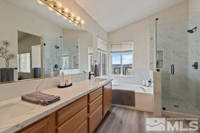 5284 Tappan Ct, Reno, NV 89523 - bathroom featuring lofted ceiling, wood finished floors, a stall shower, a garden tub, and double vanity