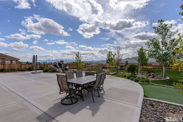 9825 Hayfield Dr, Sparks, NV 89441 - view of patio with outdoor dining area, a fenced backyard, and a mountain view