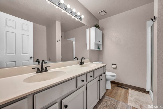 5190 Orinda Dr, Sparks, NV 89436 - full bath with toilet, double vanity, a shower stall, baseboards, and a textured ceiling