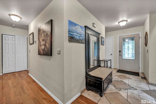 5190 Orinda Dr, Sparks, NV 89436 - entrance foyer featuring a textured ceiling, baseboards, a textured wall, and light wood finished floors