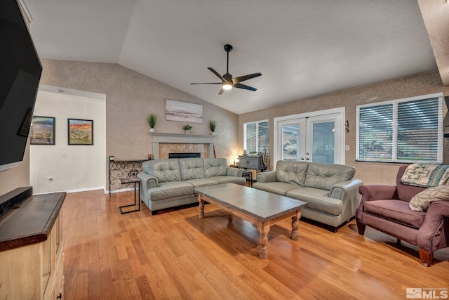 5190 Orinda Dr, Sparks, NV 89436 - living area with a fireplace, a ceiling fan, french doors, lofted ceiling, and light wood-type flooring