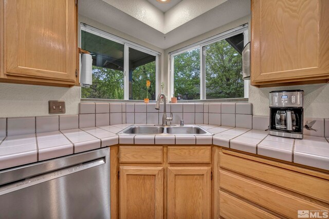 5190 Orinda Dr, Sparks, NV 89436 - kitchen featuring dishwasher, a sink, tile counters, decorative backsplash, and light brown cabinetry