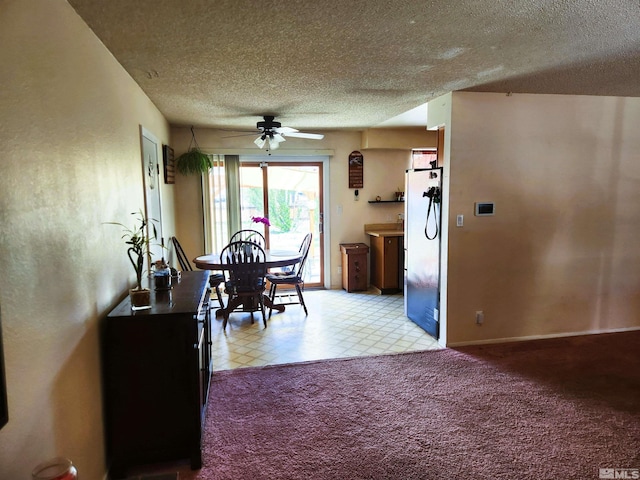 17385 Egret Ln, Reno, NV 89508 - dining space with a textured ceiling, a ceiling fan, light floors, baseboards, and light carpet