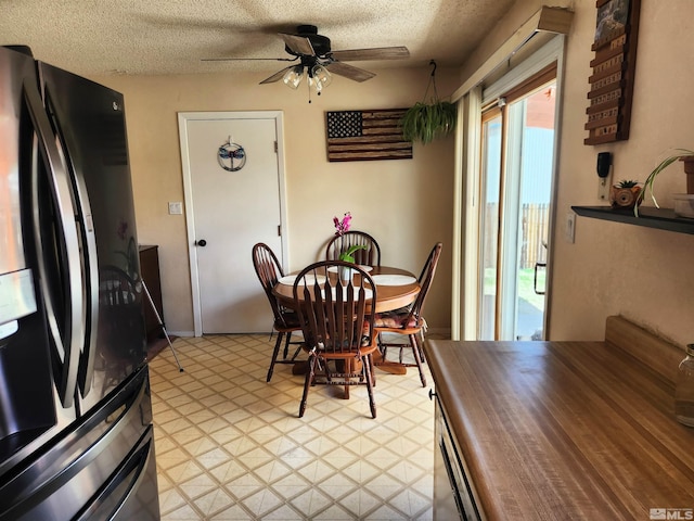 17385 Egret Ln, Reno, NV 89508 - dining space featuring light flooring, a ceiling fan, and a textured ceiling