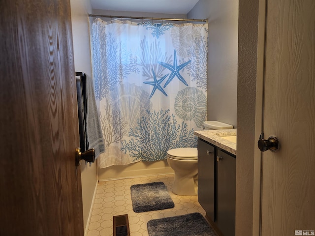 17385 Egret Ln, Reno, NV 89508 - bathroom featuring vanity, toilet, tile patterned floors, and shower / bath combo with shower curtain