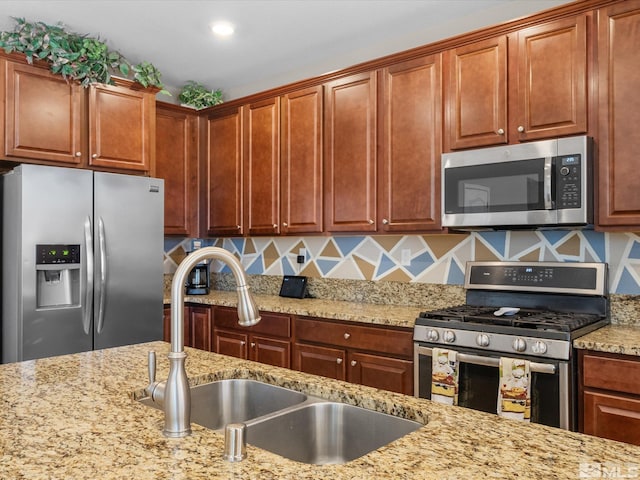 2401 Bridgetown Loop, Sparks, NV 89436 - kitchen featuring appliances with stainless steel finishes, a sink, and light stone countertops