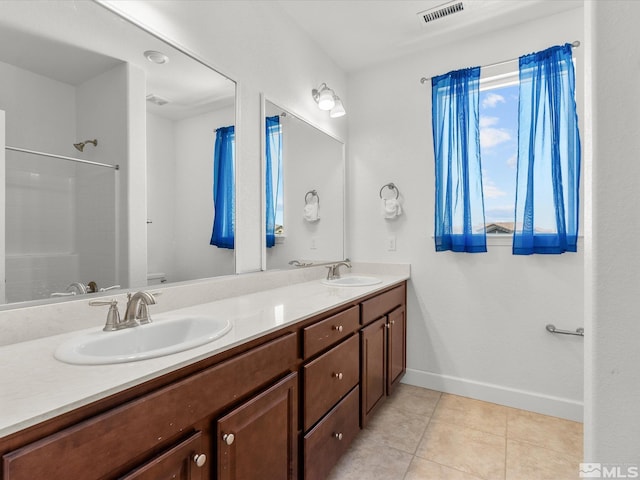 2401 Bridgetown Loop, Sparks, NV 89436 - full bath with baseboards, double vanity, tile patterned floors, toilet, and a shower