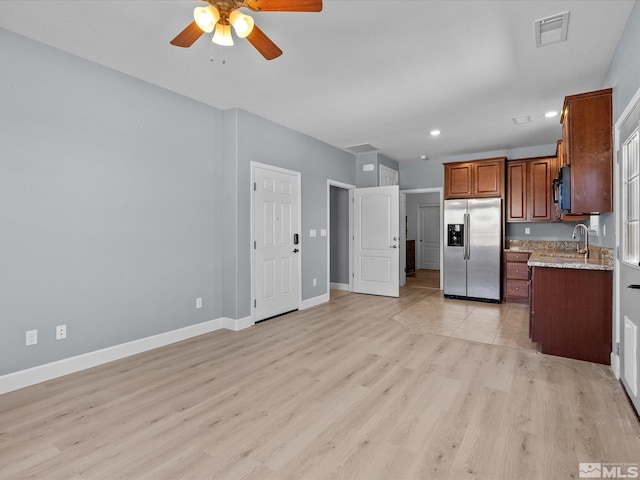 2401 Bridgetown Loop, Sparks, NV 89436 - kitchen with stainless steel refrigerator with ice dispenser, ceiling fan, light wood finished floors, baseboards, and black microwave