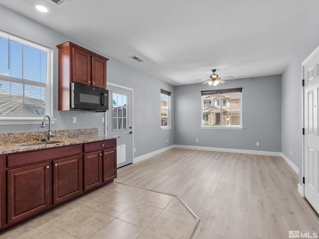 2401 Bridgetown Loop, Sparks, NV 89436 - kitchen featuring a sink, black microwave, a ceiling fan, light wood-type flooring, and light stone counters