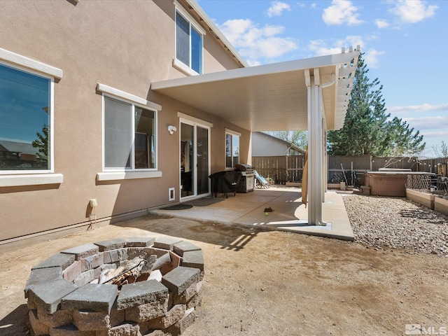2401 Bridgetown Loop, Sparks, NV 89436 - view of patio / terrace featuring an outdoor fire pit, a hot tub, and a fenced backyard