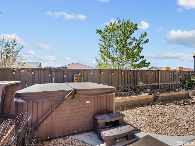 2401 Bridgetown Loop, Sparks, NV 89436 - view of patio / terrace featuring a hot tub, a garden, and a fenced backyard