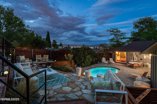 2135 Skyline Blvd, Reno, NV 89509 - pool at dusk with a patio area, a fenced backyard, and a jacuzzi
