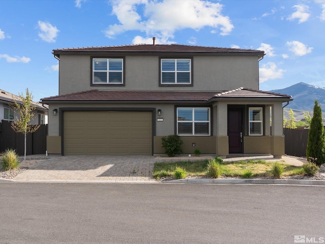 213 Enclave Key Ct, Reno, NV 89506 - traditional home with fence, stucco siding, a garage, a mountain view, and a tile roof