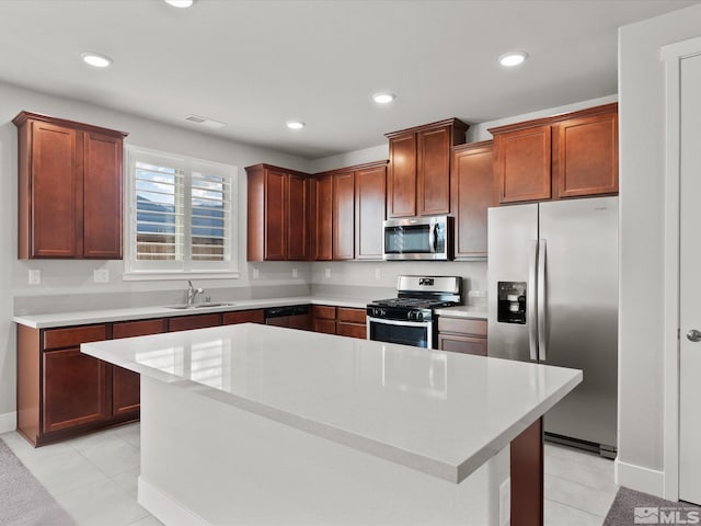213 Enclave Key Ct, Reno, NV 89506 - kitchen featuring stainless steel appliances, a sink, light countertops, light tile patterned floors, and recessed lighting