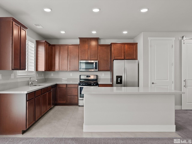 213 Enclave Key Ct, Reno, NV 89506 - kitchen with appliances with stainless steel finishes, a sink, light countertops, a kitchen island, and recessed lighting
