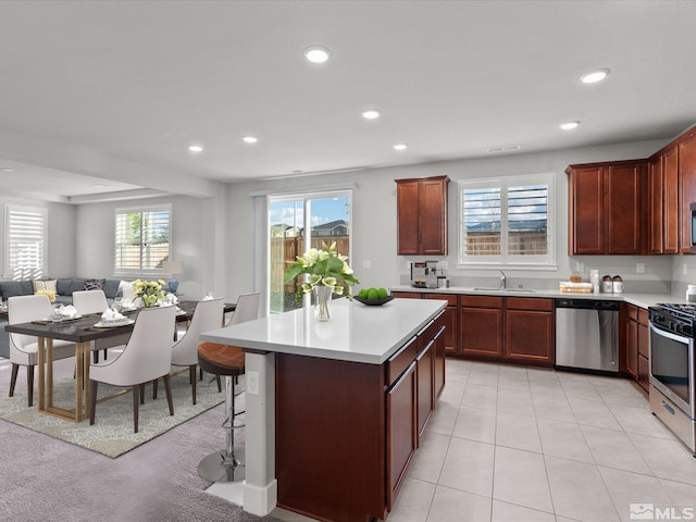 213 Enclave Key Ct, Reno, NV 89506 - kitchen featuring stainless steel appliances, a sink, light countertops, recessed lighting, and open floor plan