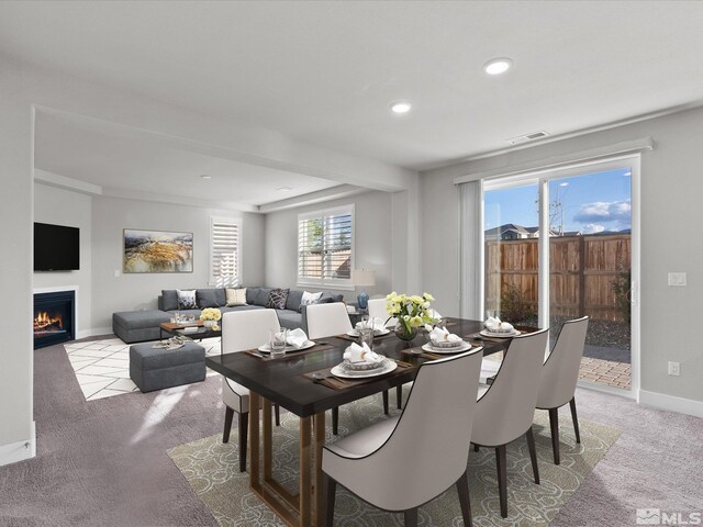 213 Enclave Key Ct, Reno, NV 89506 - dining area featuring light carpet, a warm lit fireplace, baseboards, and recessed lighting