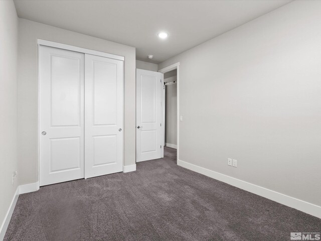 213 Enclave Key Ct, Reno, NV 89506 - unfurnished bedroom with baseboards, dark colored carpet, a closet, and recessed lighting