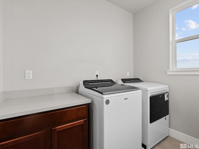 213 Enclave Key Ct, Reno, NV 89506 - laundry room featuring washing machine and dryer, cabinet space, and baseboards
