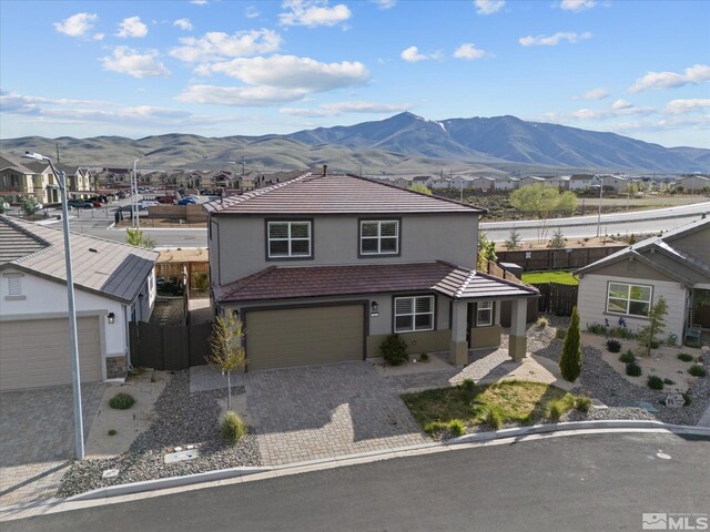 213 Enclave Key Ct, Reno, NV 89506 - traditional-style home featuring a mountain view, fence, stucco siding, decorative driveway, and a tile roof