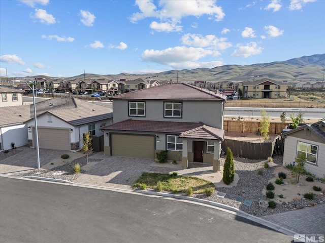 213 Enclave Key Ct, Reno, NV 89506 - traditional-style home featuring a residential view, fence, stucco siding, a tile roof, and a mountain view