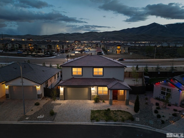 213 Enclave Key Ct, Reno, NV 89506 - view of front facade with a mountain view, stucco siding, a tile roof, a residential view, and driveway