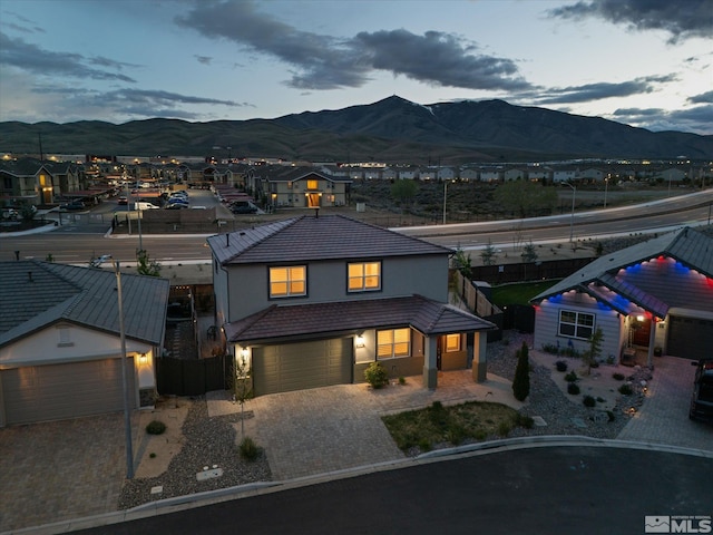 213 Enclave Key Ct, Reno, NV 89506 - view of front facade featuring a mountain view, fence, stucco siding, driveway, and an attached garage