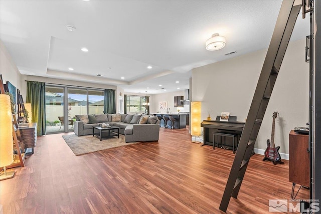 11129 Bandero Heights Ln, Reno, NV 89521 - living area featuring wood finished floors, a raised ceiling, and recessed lighting
