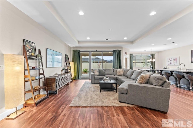 11129 Bandero Heights Ln, Reno, NV 89521 - living area featuring a tray ceiling, wood finished floors, and recessed lighting