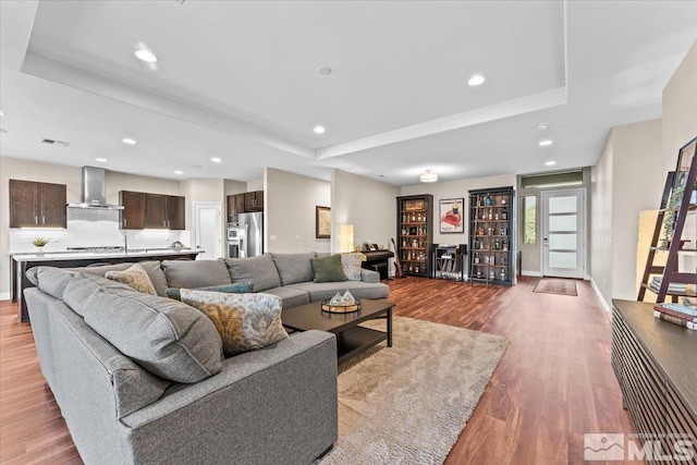 11129 Bandero Heights Ln, Reno, NV 89521 - living room featuring a raised ceiling, wood finished floors, recessed lighting, and baseboards