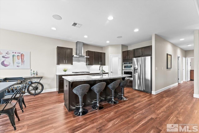 11129 Bandero Heights Ln, Reno, NV 89521 - kitchen with stainless steel appliances, wall chimney exhaust hood, a sink, baseboards, and dark wood-style flooring