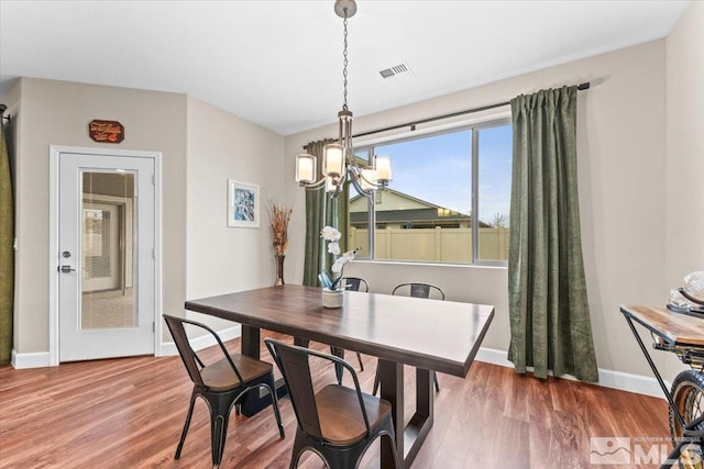 11129 Bandero Heights Ln, Reno, NV 89521 - dining space with a chandelier, wood finished floors, and baseboards