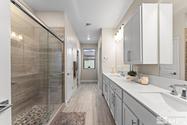11129 Bandero Heights Ln, Reno, NV 89521 - bathroom with a stall shower, double vanity, recessed lighting, and baseboards
