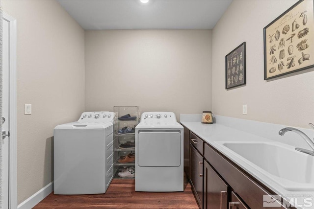 11129 Bandero Heights Ln, Reno, NV 89521 - laundry room with separate washer and dryer, dark wood-style flooring, cabinet space, and baseboards