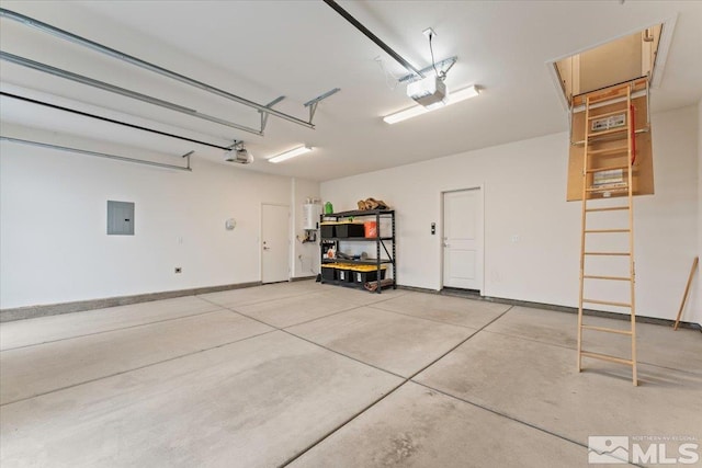 11129 Bandero Heights Ln, Reno, NV 89521 - garage with electric panel, a garage door opener, and baseboards