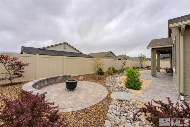 11129 Bandero Heights Ln, Reno, NV 89521 - view of patio with a fenced backyard and a fire pit