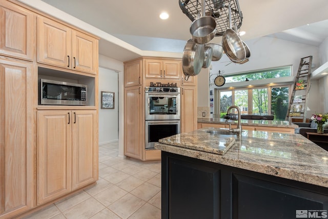 971 Fieldgate Way, Gardnerville, NV 89460 - kitchen with stainless steel appliances, light brown cabinets, light stone countertops, light tile patterned floors, and a sink