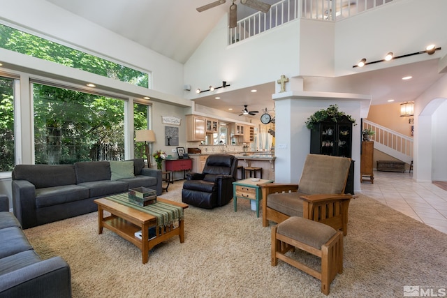 971 Fieldgate Way, Gardnerville, NV 89460 - living area featuring a ceiling fan, a towering ceiling, stairway, light tile patterned floors, and arched walkways