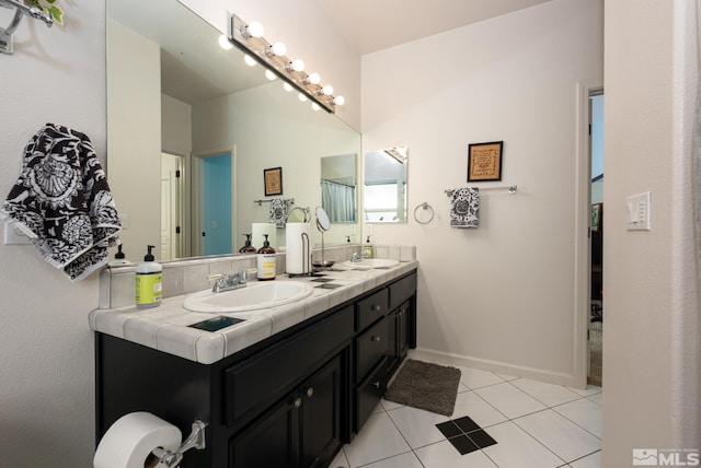 971 Fieldgate Way, Gardnerville, NV 89460 - bathroom featuring tile patterned floors, double vanity, and baseboards