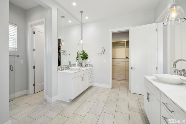 1009 Tremolite, Reno, NV 89511 - bathroom featuring recessed lighting, a walk in closet, two vanities, and baseboards
